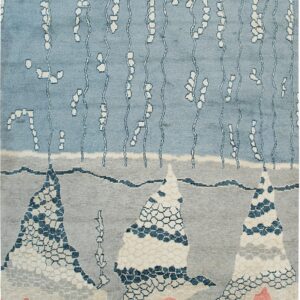 Blue, gray, and coral rug with abstract mountains, vertical white lines, and hexagonal patterns.