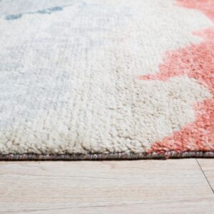 Textured rug corner with white, coral, and blue abstract patterns on light wood plank flooring.
