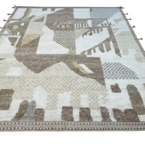 Cream and brown high-low pile rug with an abstract geometric pattern and decorative border tassels.