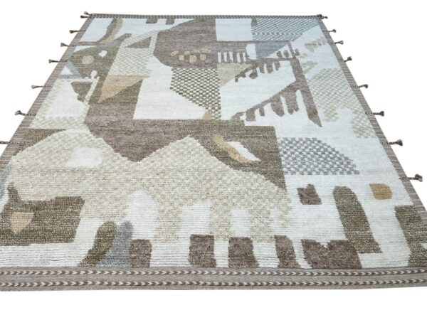 Cream and brown high-low pile rug with an abstract geometric pattern and decorative border tassels.