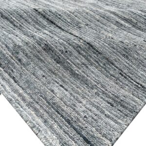 Close-up of a heathered gray rug featuring pronounced thick textured rows and ribbed pile.