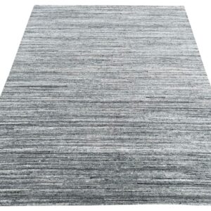 A rectangular rug featuring a textured horizontal stripe pattern in charcoal and gray.
