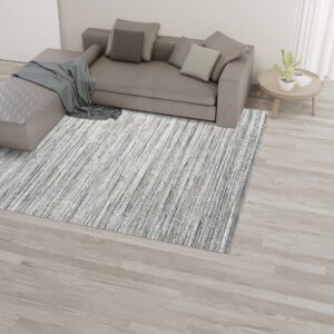 Streaked gray and white rug grounding a neutral living space with a sectional couch.