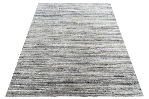 Rectangular gray and white rug featuring a dense, horizontally striped texture.