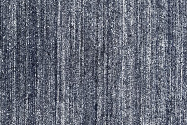 Dark blue and gray speckled rug featuring a dense, textured pile with vertical striping.