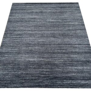 Rectangular low pile rug featuring a striated horizontal pattern in mixed dark gray and white.