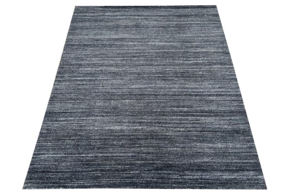 Rectangular low pile rug featuring a striated horizontal pattern in mixed dark gray and white.