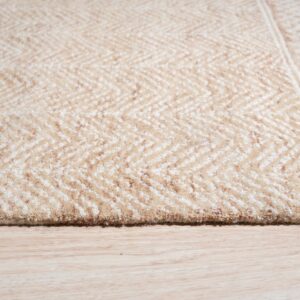 Beige and cream chevron rug detail showing high pile texture on light wood plank flooring.
