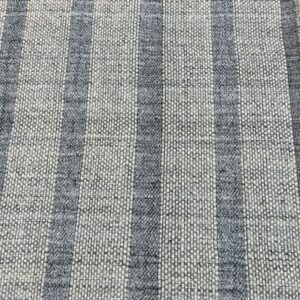 Gray and off-white striped rug featuring flatweave background and contrasting raised loop-pile stripes.