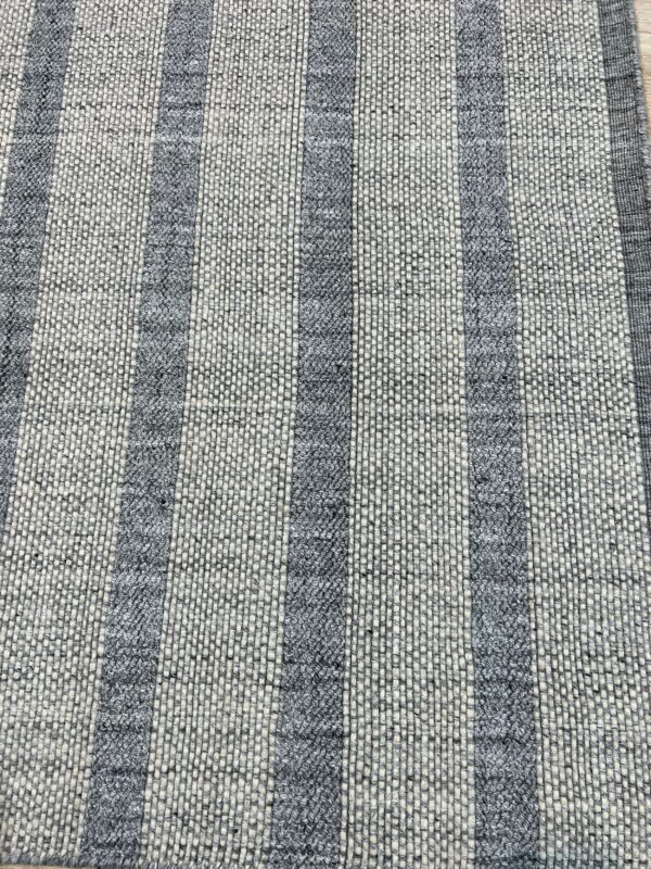Gray and off-white striped rug featuring flatweave background and contrasting raised loop-pile stripes.