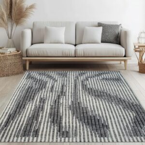Gray and white vertically striped rug on light wood floor below a beige modern sofa.
