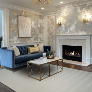 Low-pile cream rug with subtle diagonal texture anchors a blue sofa and gold coffee table.