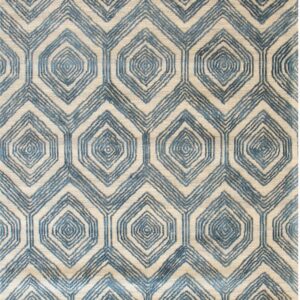 Textured rug featuring an interlocking blue and beige pattern of hexagons surrounding concentric diamond shapes.