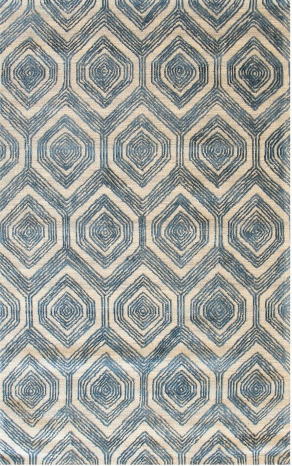 Textured rug featuring an interlocking blue and beige pattern of hexagons surrounding concentric diamond shapes.