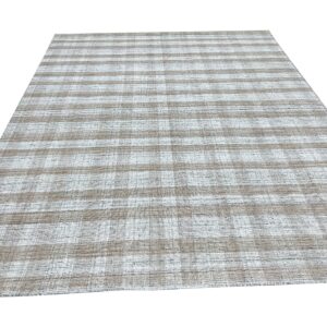 Taupe and white flatweave rug displaying a subtle checkered stripe pattern on a white background.