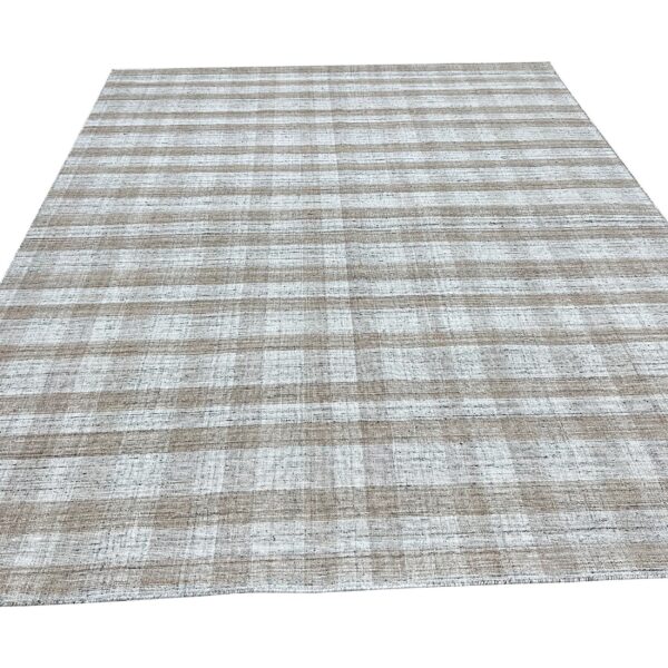 Taupe and white flatweave rug displaying a subtle checkered stripe pattern on a white background.