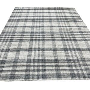 Black and white flat-woven rug featuring a visible plaid or checkered grid pattern.