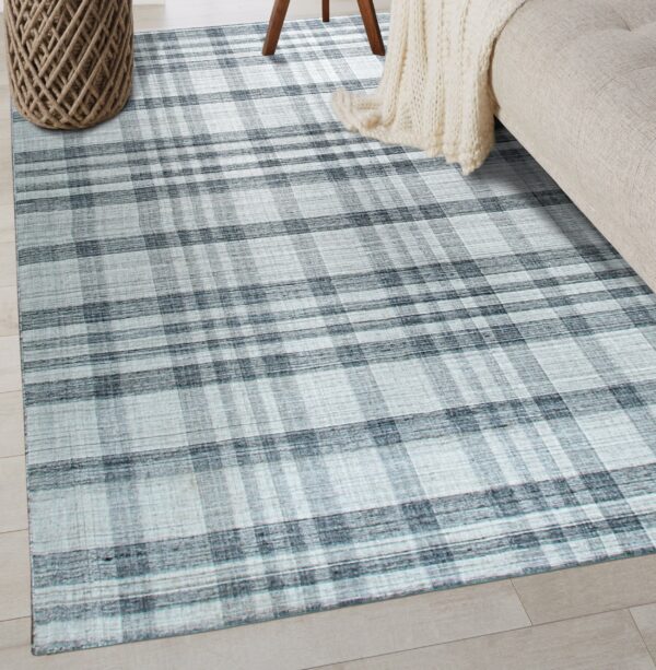 Blue and gray plaid area rug displayed on light wood floor near a beige couch and woven basket.