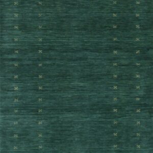 A deep teal rug with visible abrash texture and scattered light tan geometric cross patterns.