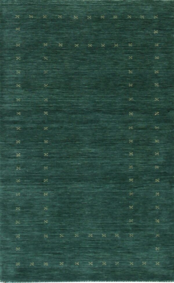 A deep teal rug with visible abrash texture and scattered light tan geometric cross patterns.