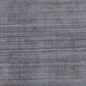 Close-up of a low-pile rug featuring a textured, blended blue-gray surface with subtle horizontal brown lines.