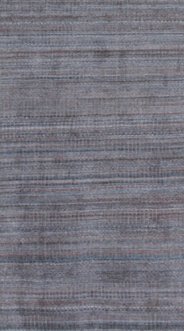 Close-up of a low-pile rug featuring a textured, blended blue-gray surface with subtle horizontal brown lines.