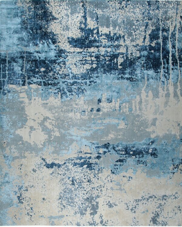 Abstract rug displaying distressed patterns of deep blue, light blue, and textured gray-beige.