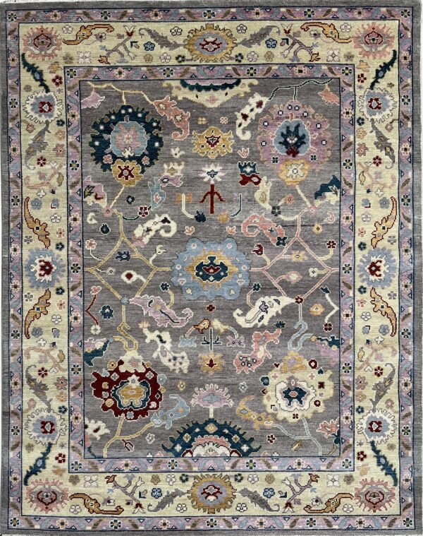 Gray traditional rug with multi-colored floral medallions and an ornate cream and lavender border.