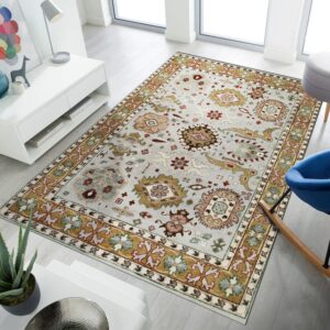 Light gray traditional area rug featuring gold, red, and green borders on light wood flooring.