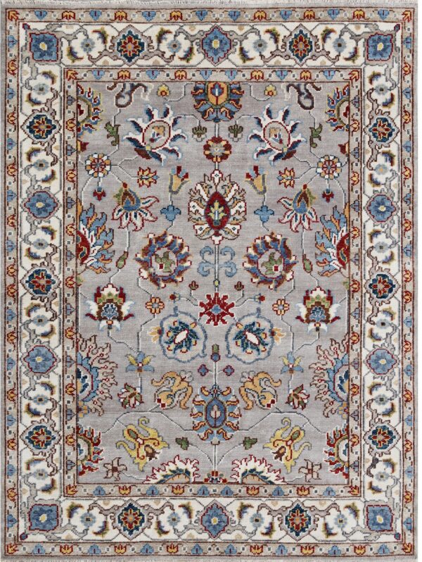 Light gray low-pile rug featuring a traditional multicolored floral medallion pattern and wide ivory borders.