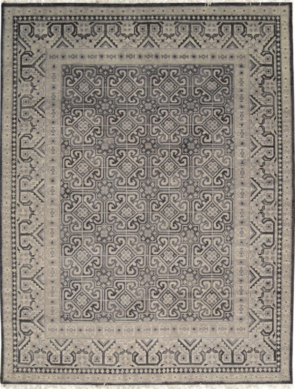 Full view of a low-pile rug with complex gray and beige interlocking geometric patterns and wide borders.