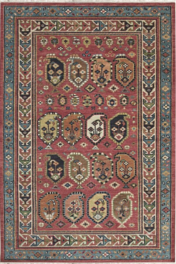 Red field rug with repeating multicolored stylized paisley motifs and a complex blue and geometric border.