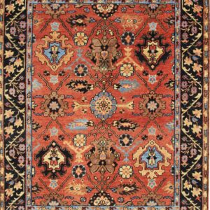 Traditional rug featuring a rust red field with gold and blue floral geometric motifs and a detailed black border.
