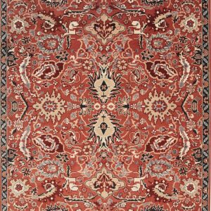 A rust red rug featuring a detailed traditional medallion and floral pattern in beige, gray, and navy.