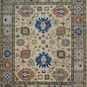 Traditional beige rug with blue and rust motifs surrounded by patterned taupe and olive green borders.