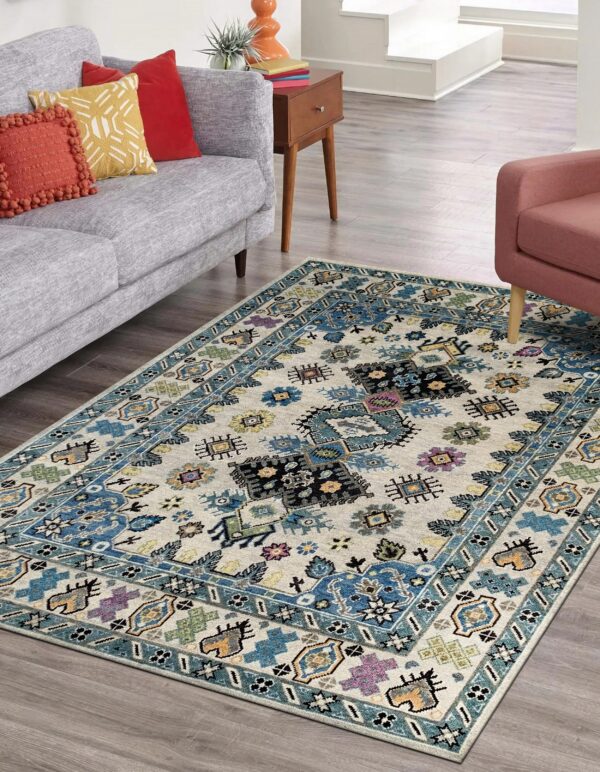 Low pile rug featuring blue and multicolor geometric patterns on gray wood floors in a bright room.