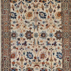Cream rug featuring an all-over traditional floral pattern in navy, light blue, and rust tones.