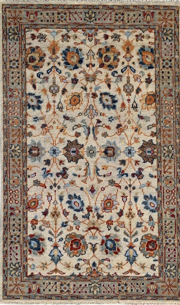 Cream rug featuring an all-over traditional floral pattern in navy, light blue, and rust tones.