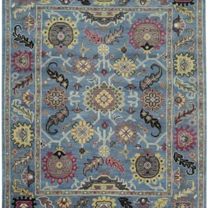 Blue rug featuring a detailed traditional floral and botanical pattern in yellow, burgundy, and gray.