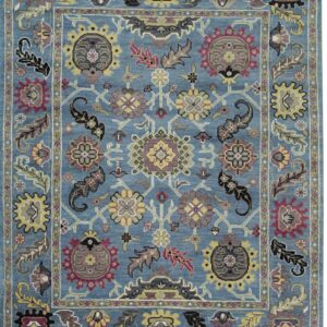 Medium pile rug with a blue field, intricate floral pattern in yellow, maroon, black, and gray.
