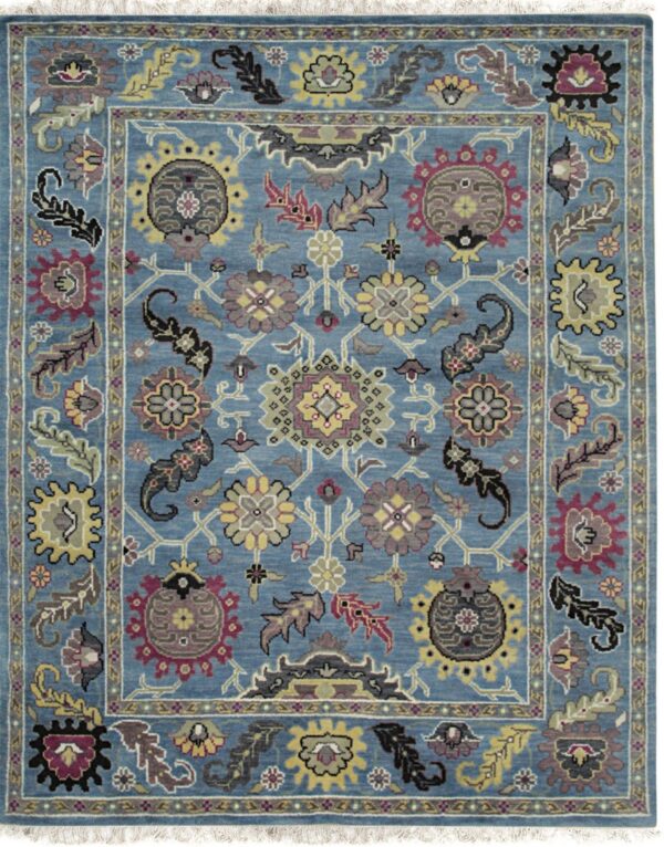 Medium pile rug with a blue field, intricate floral pattern in yellow, maroon, black, and gray.