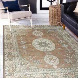 Geometric brown and cream rug sits on white tile flooring next to a beige chair and wicker basket.