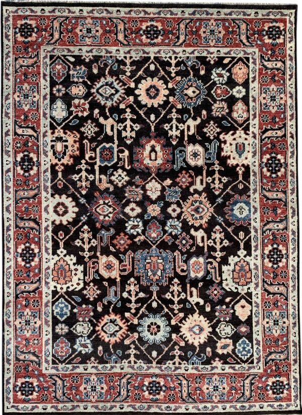 Dark pile rug with a dense, traditional pattern in red, navy, cream, and peach colors on a black field.