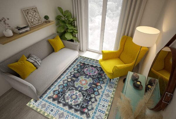 A charcoal rug with colorful geometric patterns sits between a light gray sofa and a yellow chair.