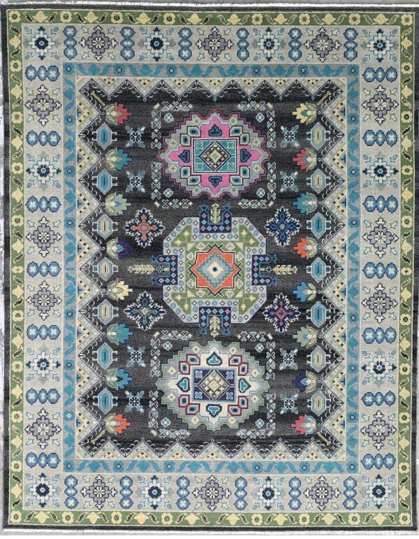Dark gray rug with high-contrast geometric medallions and borders in blue, pink, light gray, and green.