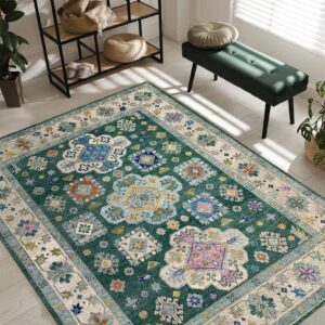Green traditional patterned rug sits on light flooring surrounded by plants and a green velvet bench.