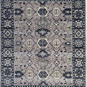 Ornate traditional rug with a gray-purple field, navy blue medallion, and geometric border patterns.