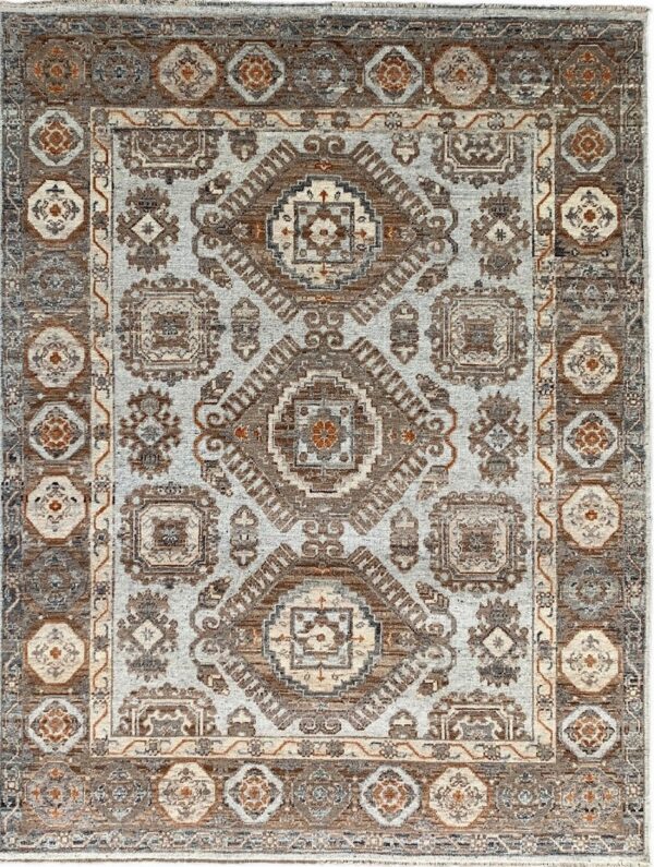 Light gray rug featuring intricate brown and rust traditional geometric medallion and borders.