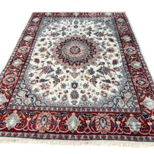 Ornate cream rug featuring a central medallion and detailed borders in red, gray, and blue.