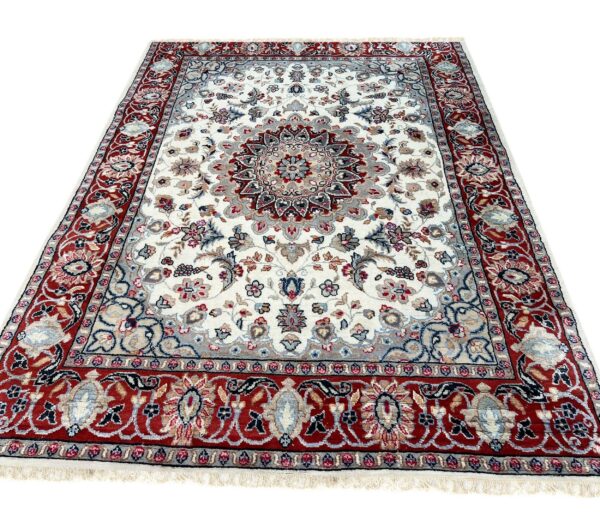Ornate cream rug featuring a central medallion and detailed borders in red, gray, and blue.